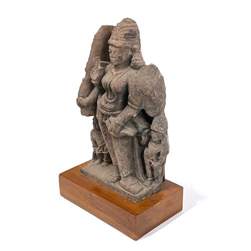 1240 - An Indian carved sandstone statue depicting the god Surya flanked by diminutive attendants, 47cmH ex... 