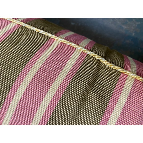 1288 - A good three seater sofa in a green and pink striped fabric, with feather filled cushions, on square... 
