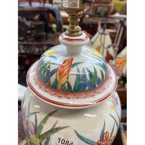 1084 - A large ceramic table lamp decorated with irises, 40cmH to base of fitting