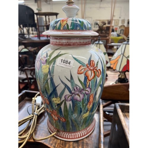 1084 - A large ceramic table lamp decorated with irises, 40cmH to base of fitting