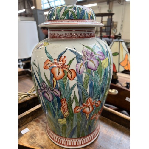 1084 - A large ceramic table lamp decorated with irises, 40cmH to base of fitting