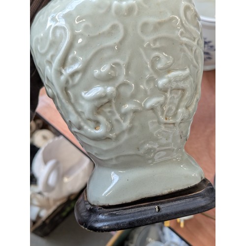160 - A Chinese twin handled celadon glazed vase converted for use as a table lamp, with twin dragon lug h... 
