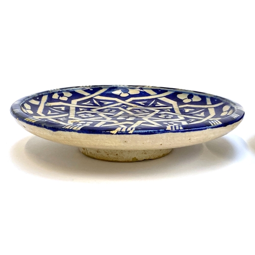 245 - A Moroccan blue and white earthenware footed dish, signed to base, 18cmD; together with a further br... 