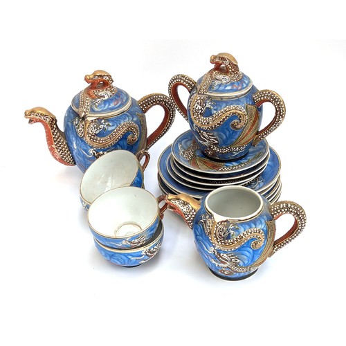 256 - A quantity of Japanese dragon moriage wares: teapots, geisha liothpane cups, saucers, etc