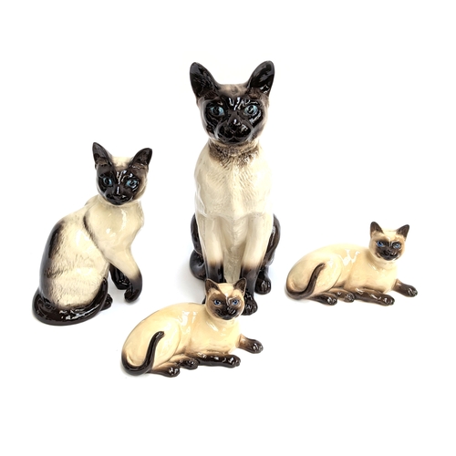 278 - Four Beswick cat figures: 35.5cmH, 25cmH, a reclining pair approx. 20cmW