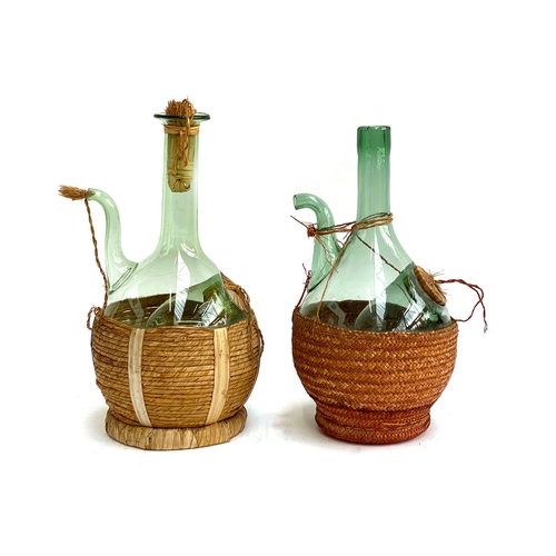 304 - Two vintage Italian glass fiasco wine decanters, the taller 33cmH