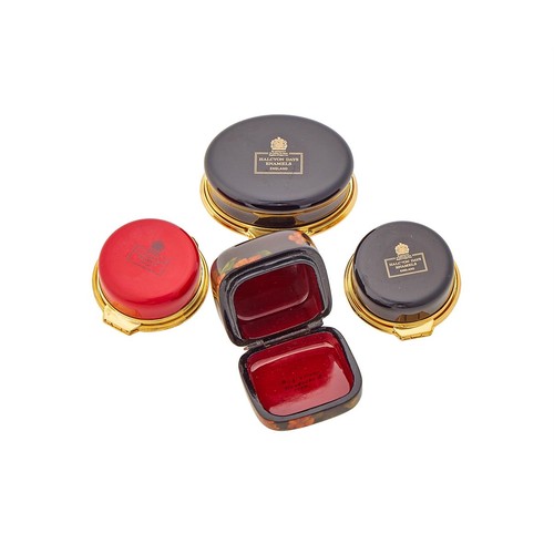 251 - Three Halcyon Days enamel pill boxes, the lids decorated with cats; together with a lacquer box (4)
