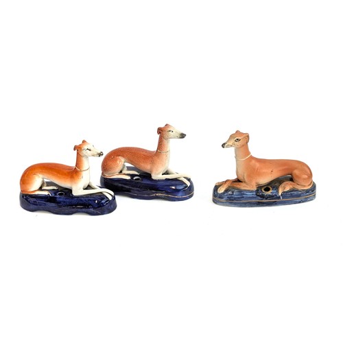 292 - A near pair of Staffordshire long dog inkwells, together with one other, each approx. 17cmL (3)