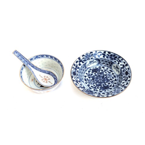 286 - An early 20th century Chinese blue and white bowl, together with a rice bowl and spoon, marked to ba... 
