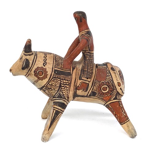 276 - A Mexican folk art terracotta figure of bull and rider, 22cmH