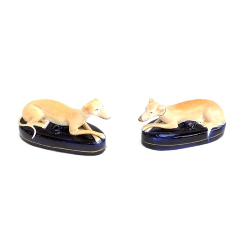 291 - A pair of Staffordshire recumbent long dog inkwells, 20cmL