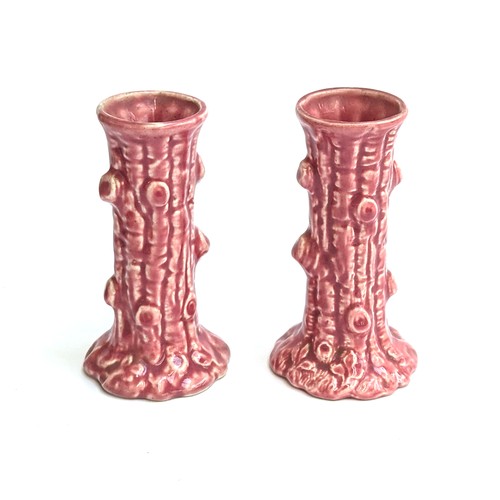 279 - A pair of pink ceramic candlesticks/vases modelled as tree trunks, 13cmH