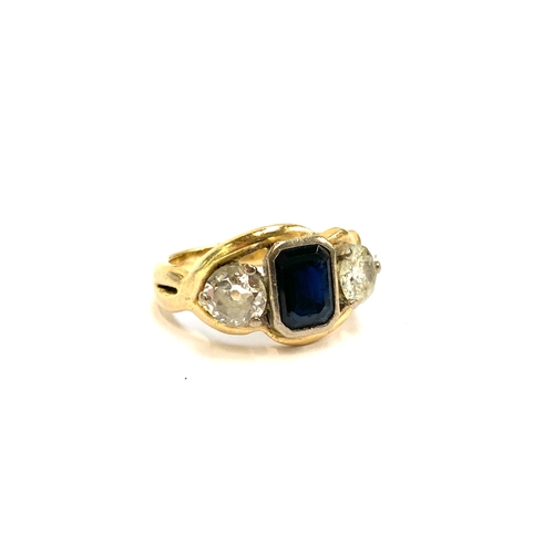 32 - A gold, sapphire and diamond trilogy ring, the emerald cut sapphire measuring 7x5mm, the diamonds ea... 