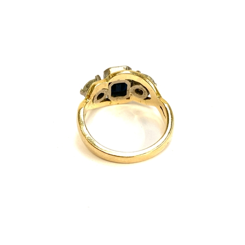 32 - A gold, sapphire and diamond trilogy ring, the emerald cut sapphire measuring 7x5mm, the diamonds ea... 