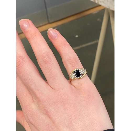 32 - A gold, sapphire and diamond trilogy ring, the emerald cut sapphire measuring 7x5mm, the diamonds ea... 