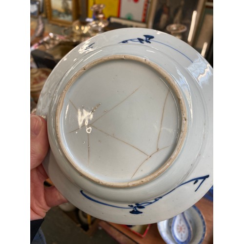 286 - An early 20th century Chinese blue and white bowl, together with a rice bowl and spoon, marked to ba... 
