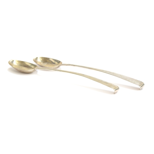 49 - A pair of Irish silver serving spoons, maker's mark IC, Dublin 1775, with crested hooked terminals, ... 