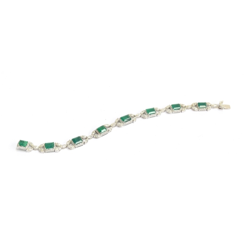 27 - An 18ct white gold emerald and diamond bracelet, the eight large emeralds approx. totalling 12.15 ca... 