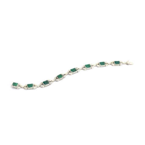 27 - An 18ct white gold emerald and diamond bracelet, the eight large emeralds approx. totalling 12.15 ca... 