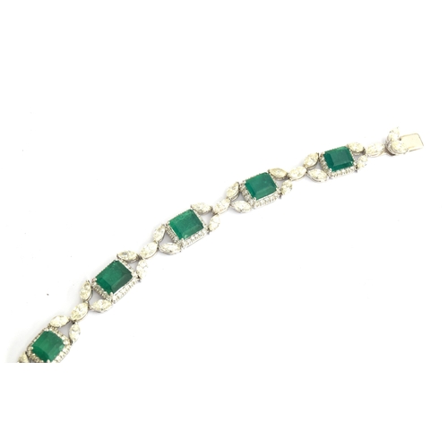 27 - An 18ct white gold emerald and diamond bracelet, the eight large emeralds approx. totalling 12.15 ca... 