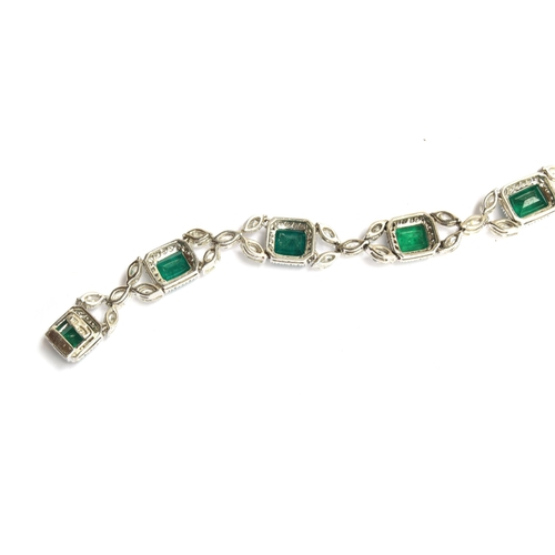 27 - An 18ct white gold emerald and diamond bracelet, the eight large emeralds approx. totalling 12.15 ca... 