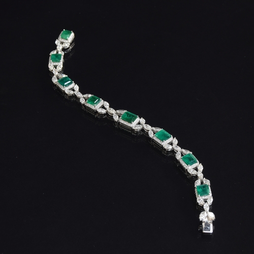 27 - An 18ct white gold emerald and diamond bracelet, the eight large emeralds approx. totalling 12.15 ca... 