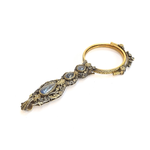32 - A pair of 19th century gold and silver lorgnettes, of pierced foliate form, bezel set with three sap... 