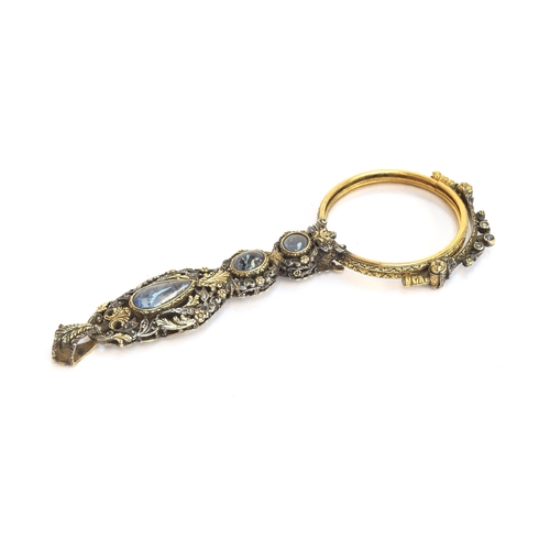 32 - A pair of 19th century gold and silver lorgnettes, of pierced foliate form, bezel set with three sap... 