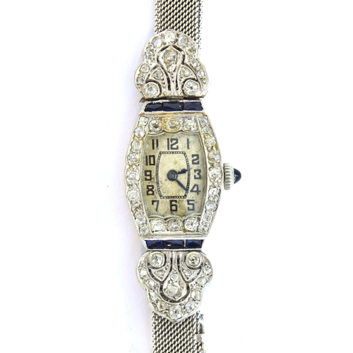 34 - An Art Deco 18ct white gold, diamond and sapphire cocktail watch, the tonneau shaped dial with Arabi... 
