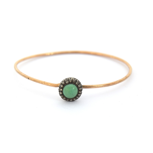 12 - A Victorian gold wire bangle set with a silver mounted turquoise cabochon and diamond cluster, the b... 