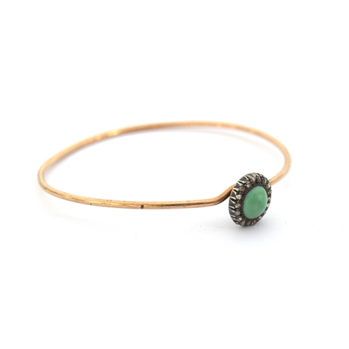 12 - A Victorian gold wire bangle set with a silver mounted turquoise cabochon and diamond cluster, the b... 