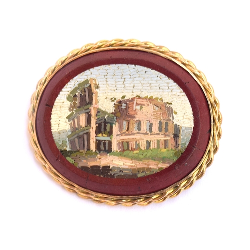 20 - A Victorian Grand Tour gold mounted double sided micromosaic brooch depicting ruins within a red bor... 
