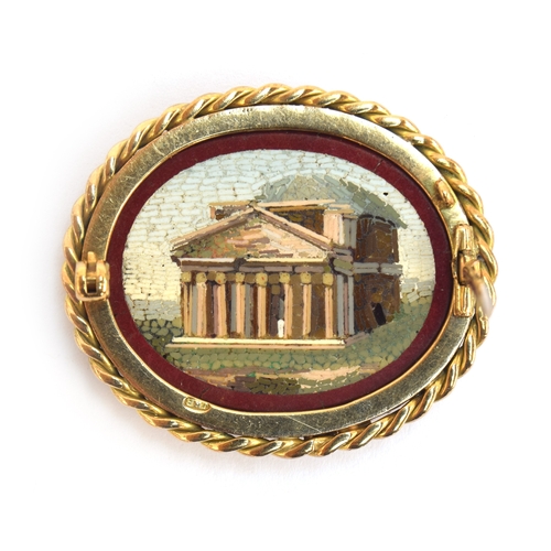 20 - A Victorian Grand Tour gold mounted double sided micromosaic brooch depicting ruins within a red bor... 
