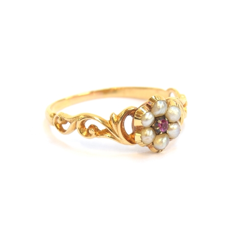 3 - An early Victorian gold, ruby and split pearl floral cluster ring with pierced foliate shoulders, si... 