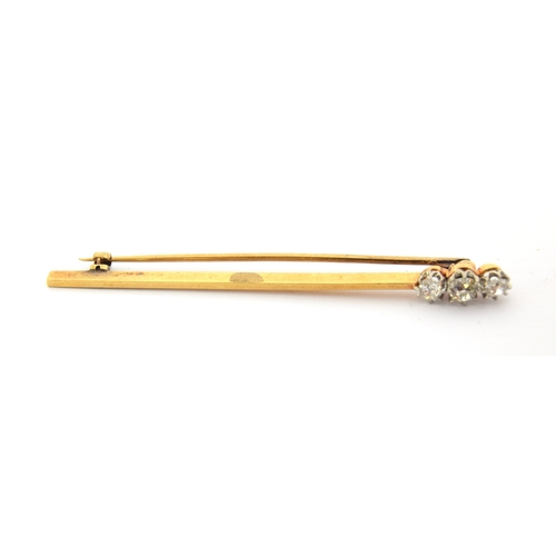17 - An Art Deco gold bar brooch set with three old cut diamonds, the largest diamond 4x3mm, unmarked but... 