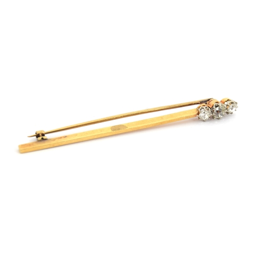 17 - An Art Deco gold bar brooch set with three old cut diamonds, the largest diamond 4x3mm, unmarked but... 