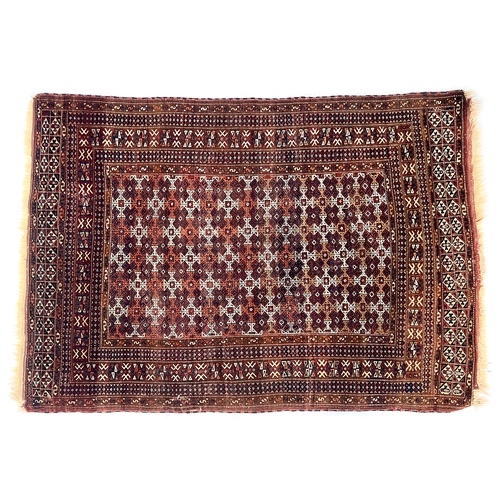 497 - A Turkmen rug, brown ground with central geometric pattern, 185x128cm