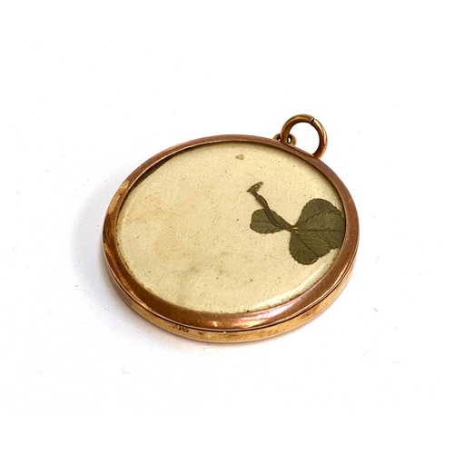 18 - An early 20th century 9ct gold double sided glazed locket, stamped 9ct, 3.5cmD, gross weight 10.9g