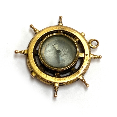 26 - A Victorian yellow metal compass pendant in the form of a ship's wheel (af), gross weight 4.3g