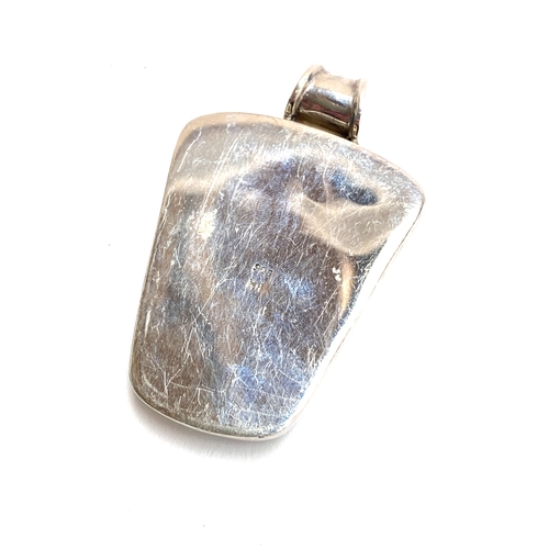 33 - A Modernist 925 silver and turquoise pendant, stamped KH, possibly Kit Heath, 6cmL