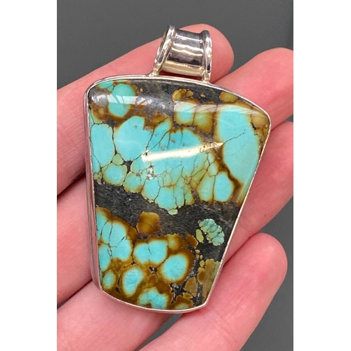33 - A Modernist 925 silver and turquoise pendant, stamped KH, possibly Kit Heath, 6cmL