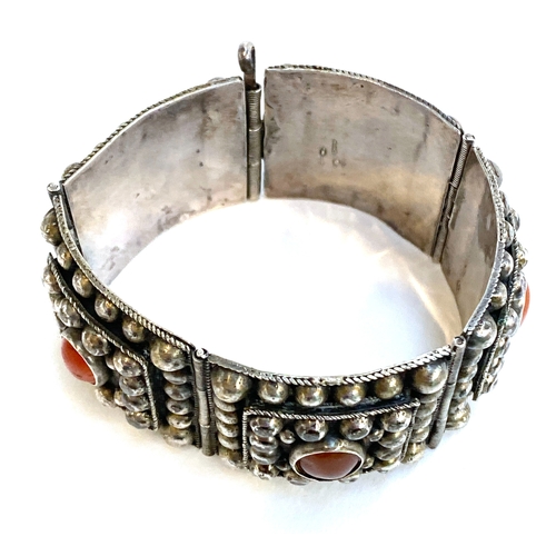 39 - A North African white metal and carnelian bracelet, fastening with a pin, 3.5cmW, 80g