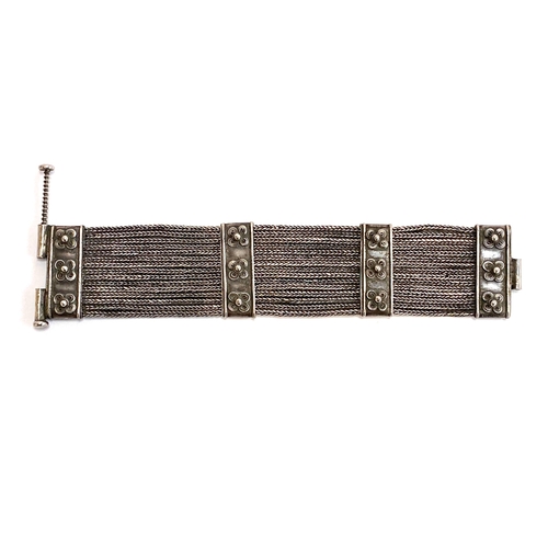 48 - An early 20th century Indian silver Rajasthani woven style bracelet with floral decoration, fastenin... 