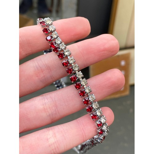 13 - A mixed lot of costume jewellery to include gold and silver tone chains, red and white paste necklac... 
