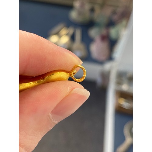 11 - Two Chinese 24ct gold pendants, one in the form of a peanut, gross weight 6g