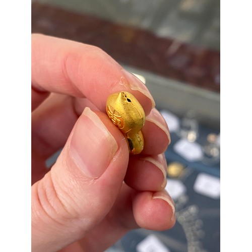 11 - Two Chinese 24ct gold pendants, one in the form of a peanut, gross weight 6g