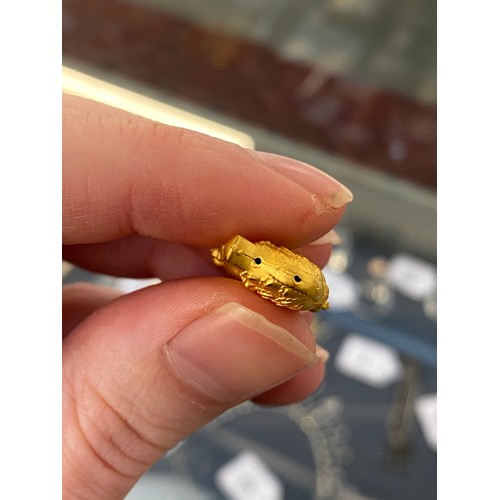 11 - Two Chinese 24ct gold pendants, one in the form of a peanut, gross weight 6g