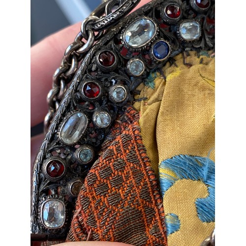 33 - A late 19th/early 20th century ornately pierced silver purse frame set with multiple gemstones to in... 