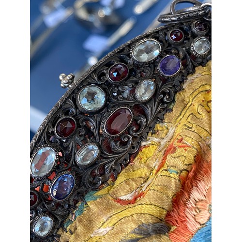 33 - A late 19th/early 20th century ornately pierced silver purse frame set with multiple gemstones to in... 