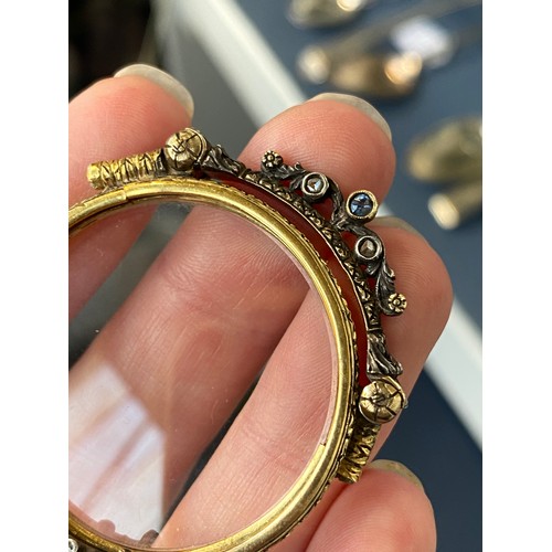 32 - A pair of 19th century gold and silver lorgnettes, of pierced foliate form, bezel set with three sap... 